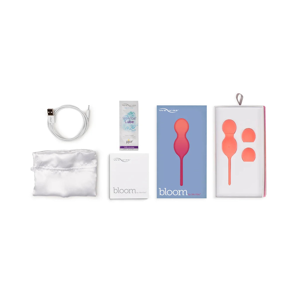 Full box contents of We-Vibe Bloom, including kegel balls, charger, carrying pouch, sample lube, and warranty/manual.