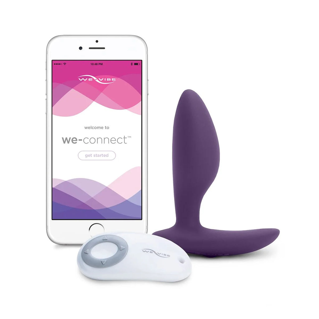 Anal vibrator next to remote and phone with app on display.