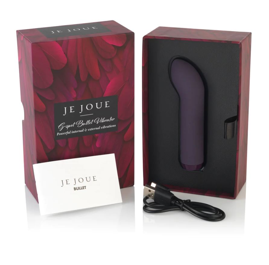 Open box with vibrator and charging cord inside.