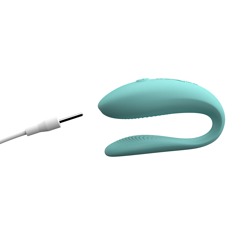 We-Vibe Sync Lite Couple's Vibrator shown next to charger.