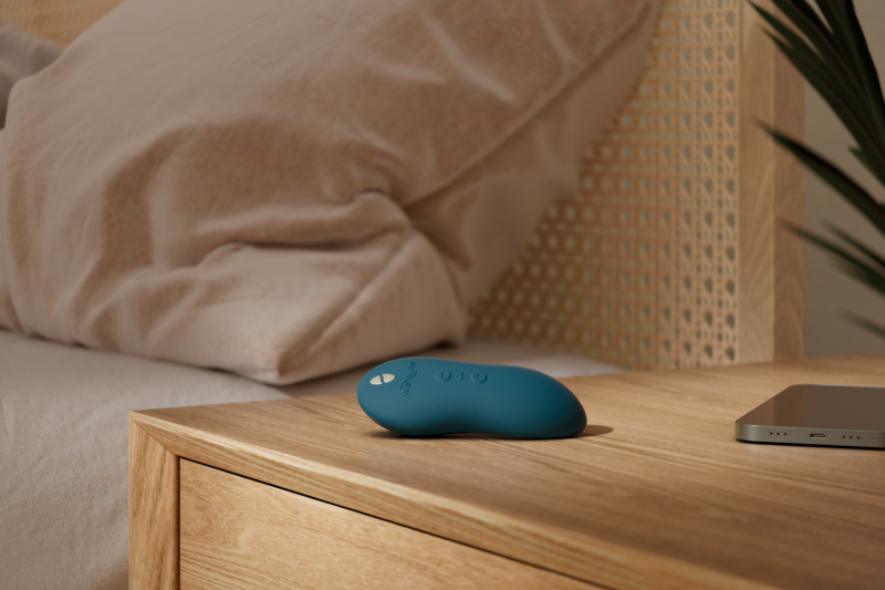 Vibrator laying on bedside table.