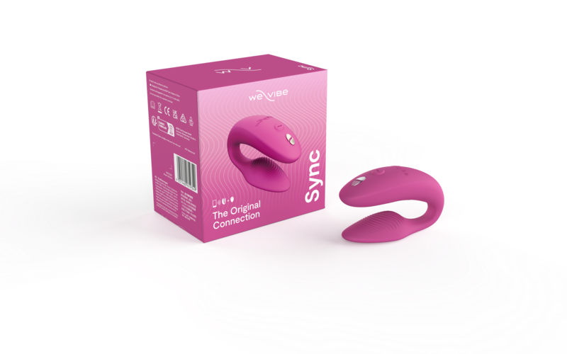 We-Vibe Sync Couple's Vibrator in pink, shown next to box.